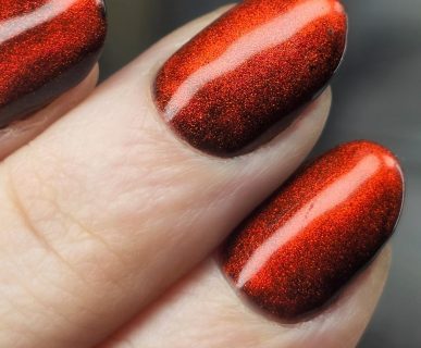 Red velvet cat-eye manicure with a smooth reflective magnetic finish created at Aesthete Beauty in Dundee