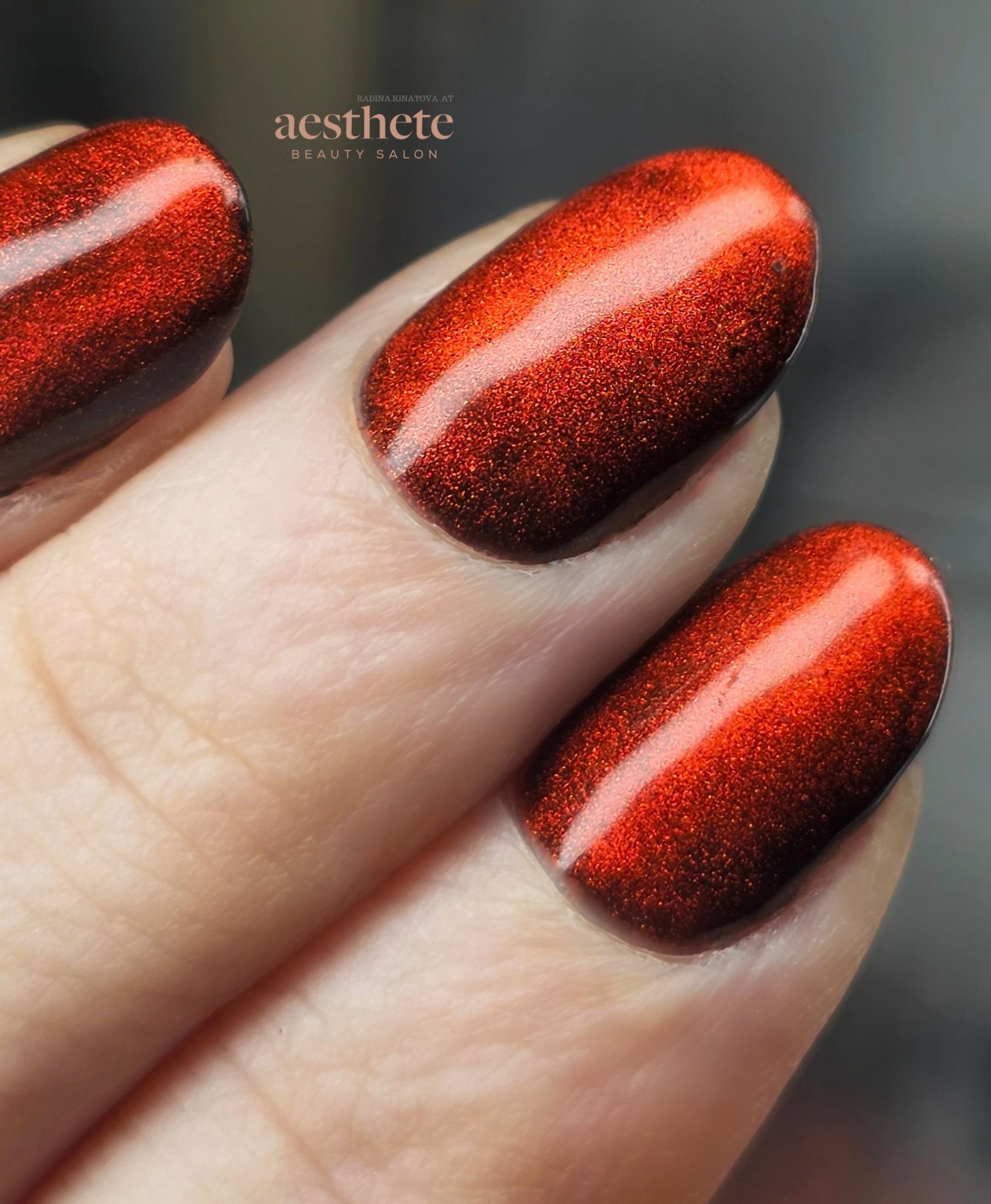Red velvet cat-eye manicure with a smooth reflective magnetic finish created at Aesthete Beauty in Dundee