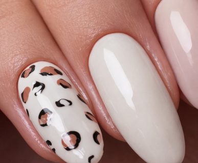 Macro close-up of a Russian Manicure showing flawless cuticle work and leopard print nail art.