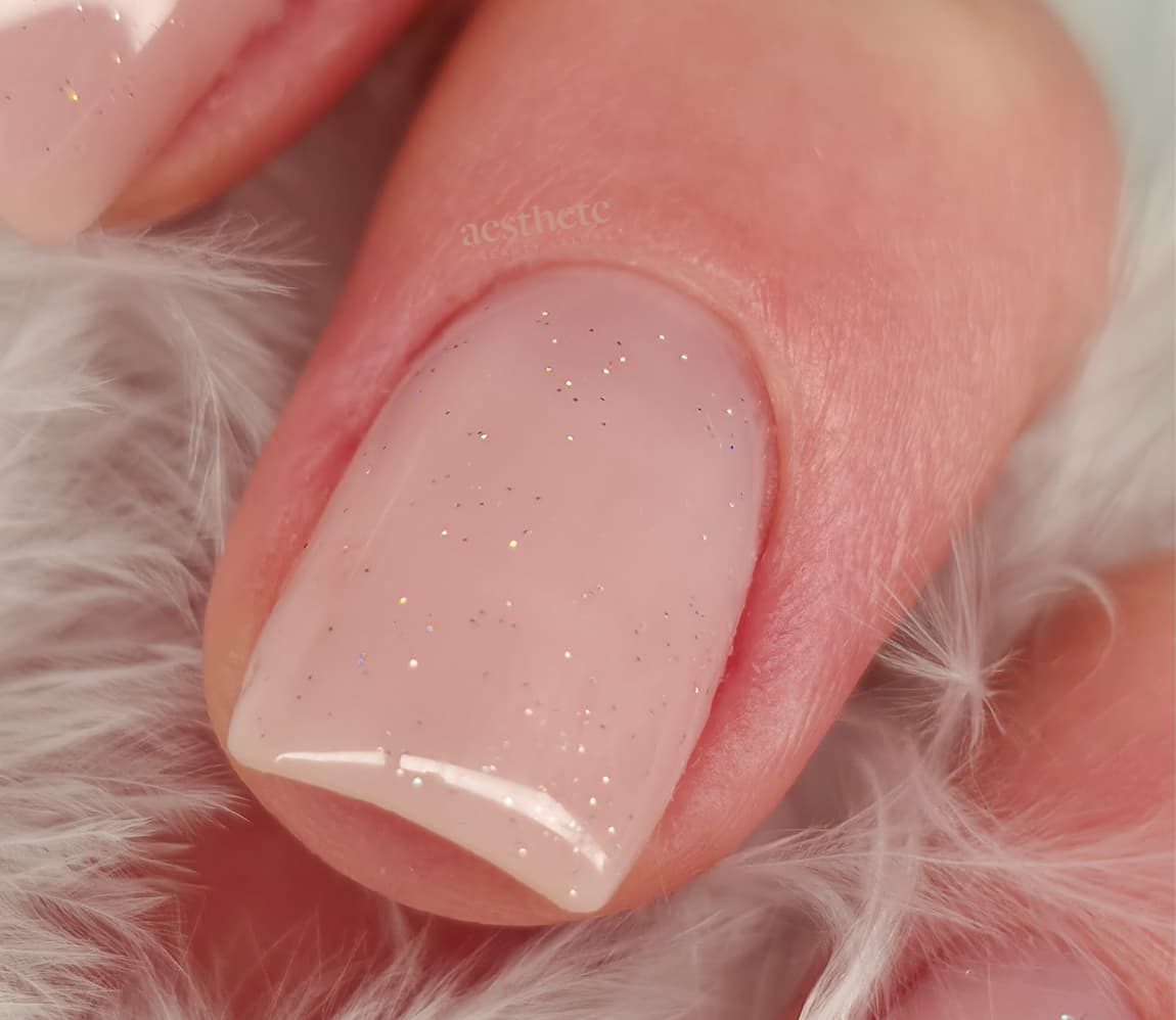 Macro close-up of BIAB nude pink shimmer nail with dual forms and Russian manicure at Aesthete Beauty Dundee