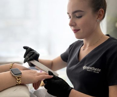 Radina Ignatova, a professional nail technician at Aesthete Beauty Salon in Dundee, performing a precision manicure treatment.
