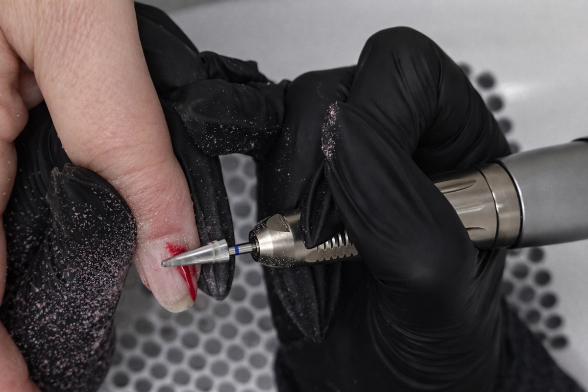 E-file product removal during nail infill process at Aesthete Beauty Dundee