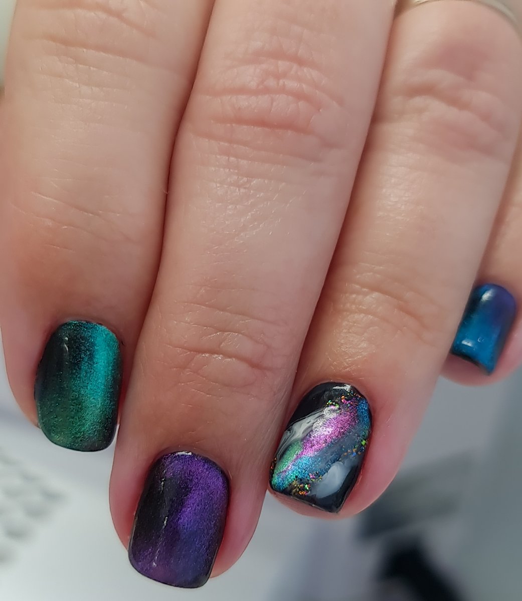 Galaxy cat-eye nails with teal purple and blue magnetic gel at Aesthete Beauty Dundee