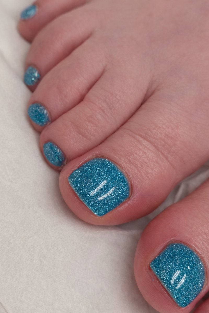 Gel polish pedicure with glitter blue finish on toes at Aesthete Beauty Dundee